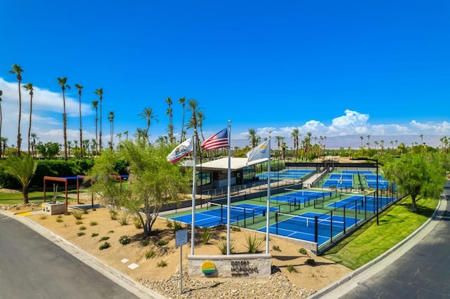 view of home's community featuring tennis court