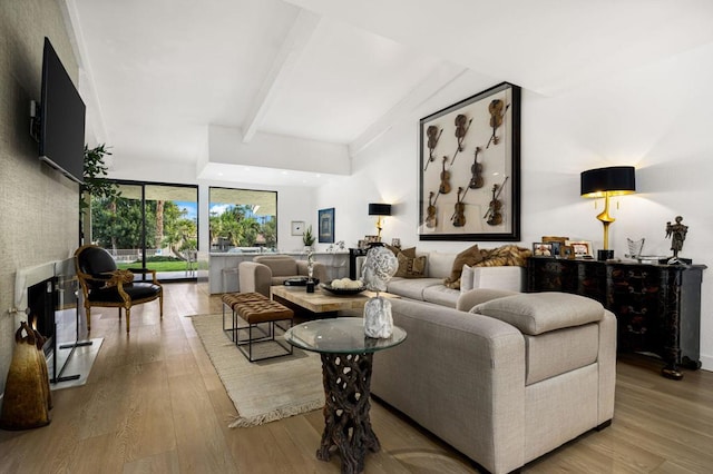 living room with beamed ceiling and light hardwood / wood-style floors