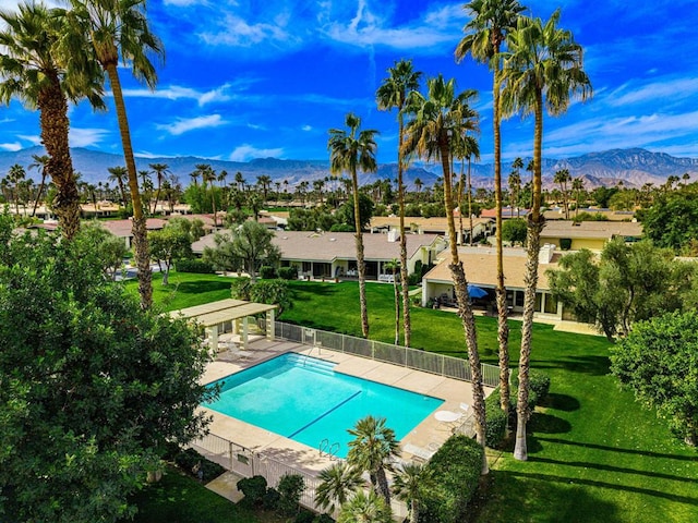 view of pool featuring a patio, a mountain view, a pergola, and a lawn