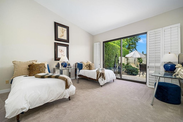 carpeted bedroom with access to exterior and vaulted ceiling