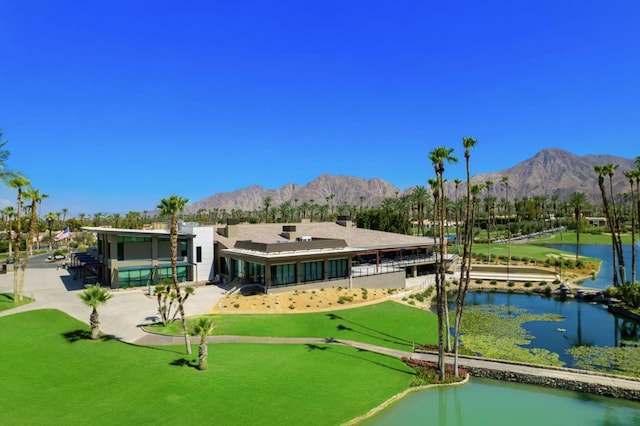 rear view of property with a water and mountain view