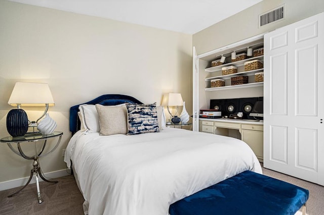 bedroom featuring light colored carpet and built in desk