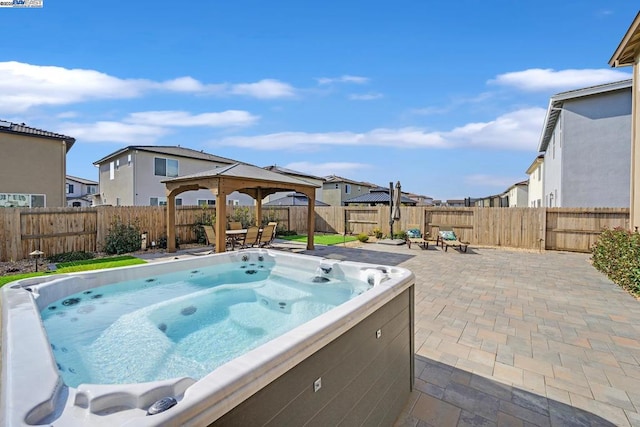 view of swimming pool featuring a gazebo, a hot tub, and a patio