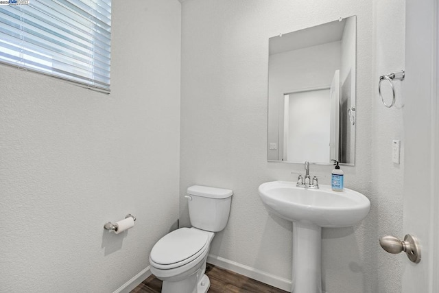 bathroom featuring sink, toilet, and hardwood / wood-style floors