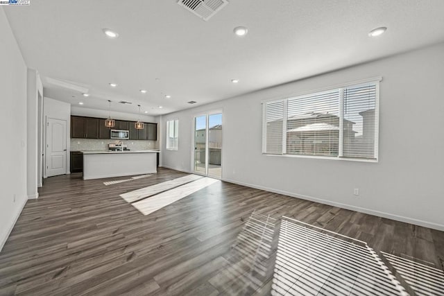 unfurnished living room featuring dark hardwood / wood-style flooring