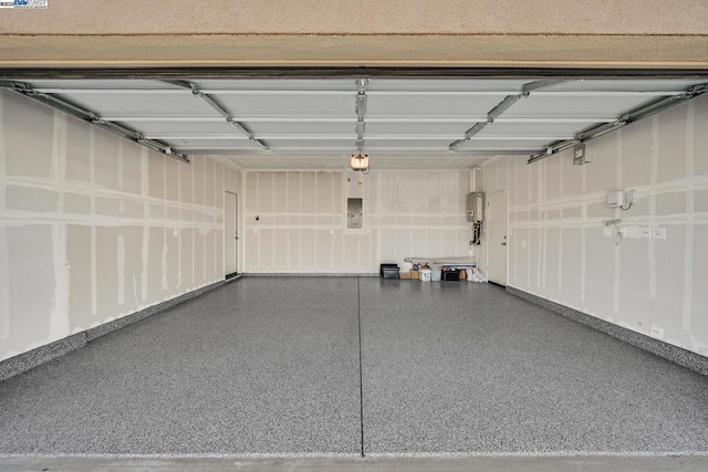 garage featuring a garage door opener and electric panel