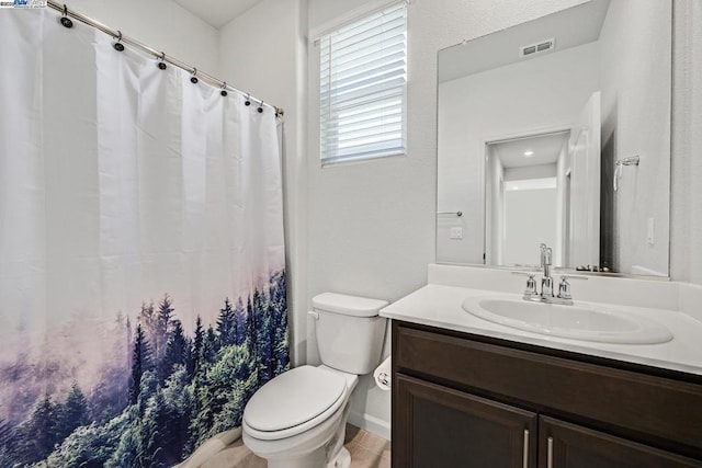 bathroom featuring tile patterned floors, vanity, and toilet