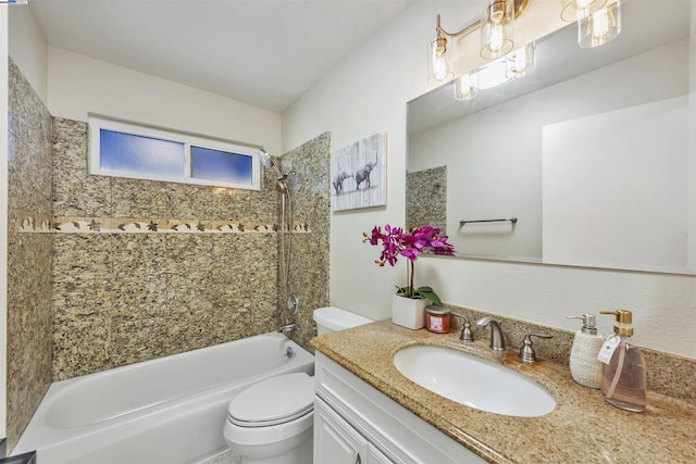 full bathroom featuring tiled shower / bath combo, vanity, and toilet