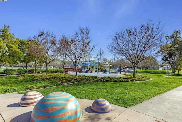 view of property's community featuring a yard and a playground