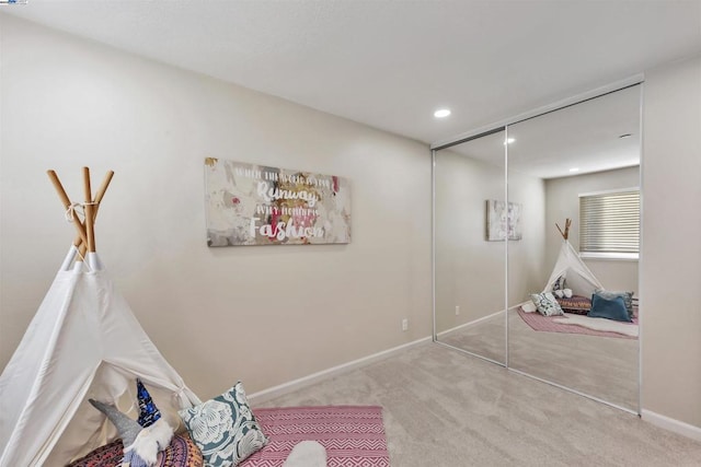 interior space featuring light colored carpet and a closet