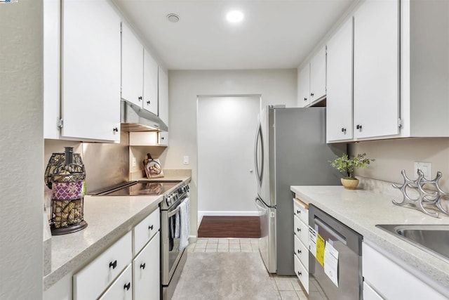 kitchen featuring white cabinetry, stainless steel appliances, sink, and light tile patterned floors