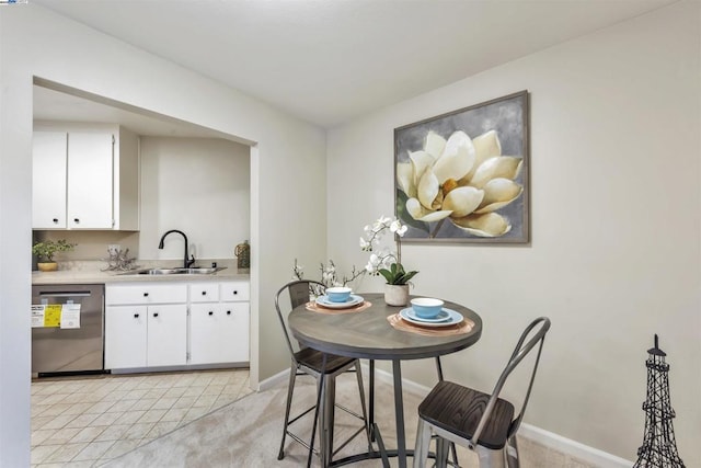 dining space featuring light tile patterned flooring and sink