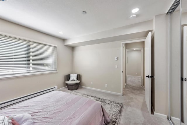 carpeted bedroom with a baseboard radiator