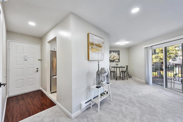 interior space with light carpet and a baseboard radiator