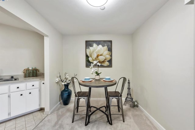 tiled dining space featuring sink