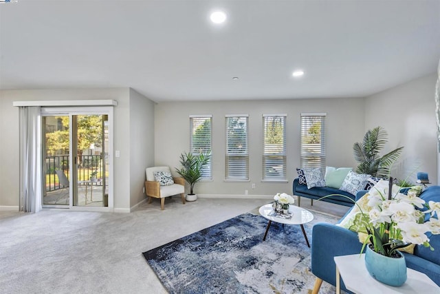 living room featuring carpet floors and a wealth of natural light