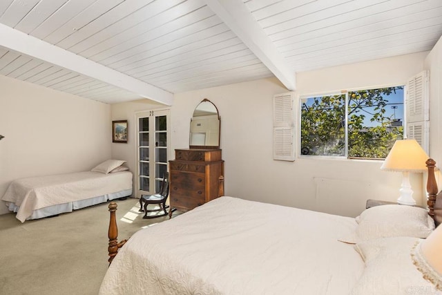 carpeted bedroom with beamed ceiling