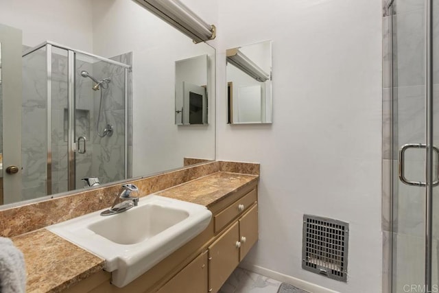 full bathroom with visible vents, marble finish floor, a stall shower, and vanity