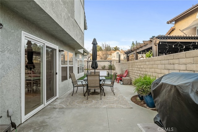 view of patio featuring area for grilling and a pergola