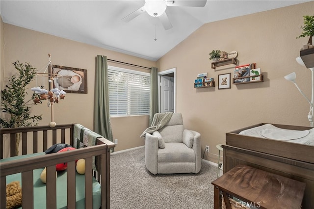 bedroom with a nursery area, ceiling fan, lofted ceiling, and carpet flooring