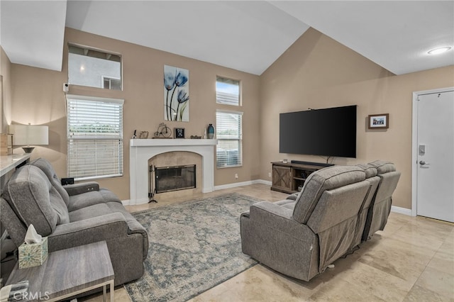 living room featuring a premium fireplace, vaulted ceiling, and a wealth of natural light