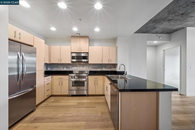 kitchen with sink, light hardwood / wood-style flooring, light brown cabinets, kitchen peninsula, and stainless steel appliances