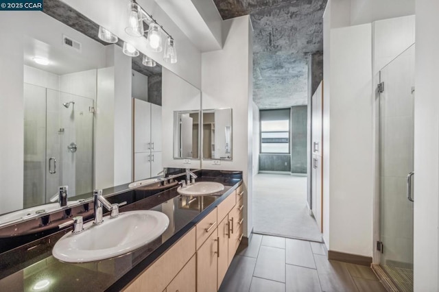 bathroom with vanity, an enclosed shower, and tile patterned flooring