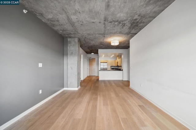 hallway with light hardwood / wood-style floors