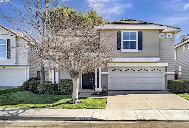 view of front property featuring a garage and a front yard