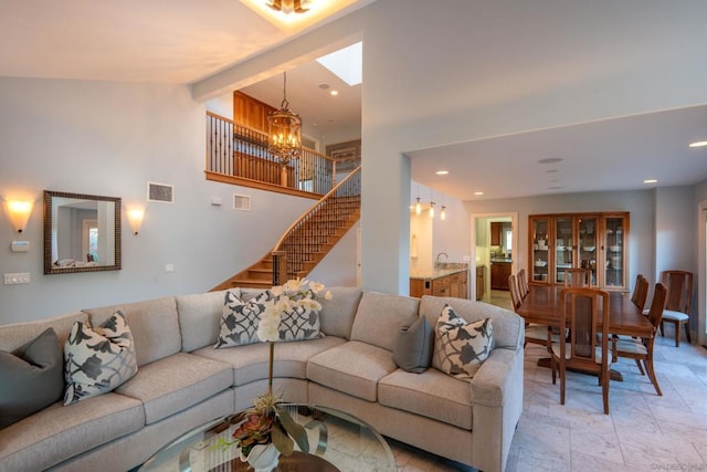 living room with beamed ceiling, high vaulted ceiling, and an inviting chandelier