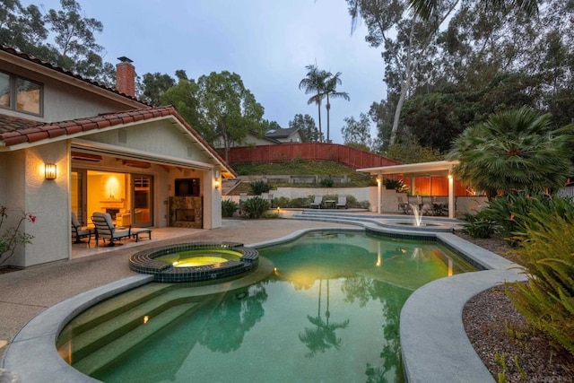 view of pool featuring an in ground hot tub and a patio