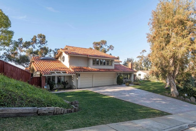 mediterranean / spanish-style house featuring a garage and a front lawn