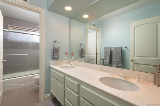 full bathroom with toilet, tile patterned floors, shower / bath combination with glass door, and vanity