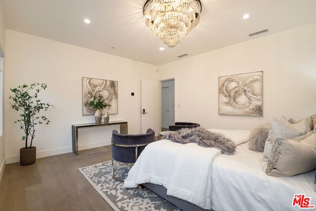 bedroom featuring an inviting chandelier and dark wood-type flooring