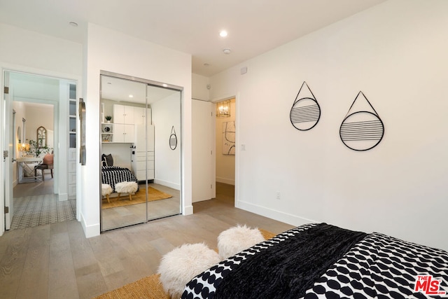 bedroom with a closet and light wood-type flooring