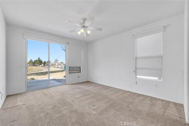 empty room with ceiling fan and carpet