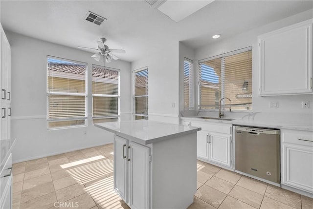 kitchen with white cabinetry, stainless steel dishwasher, a center island, and sink