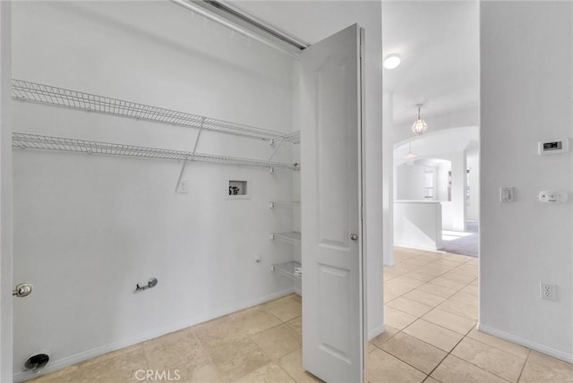 washroom featuring washer hookup and light tile patterned floors