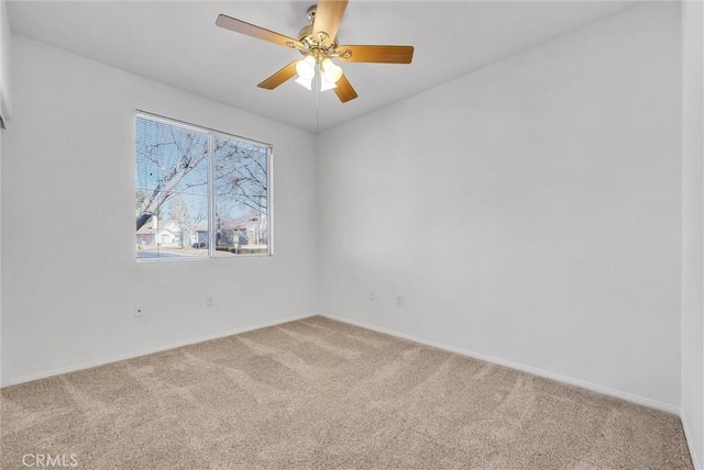 empty room featuring ceiling fan and carpet flooring