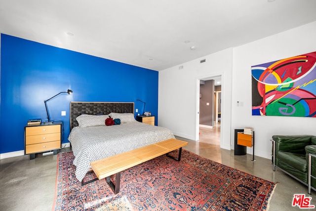 bedroom featuring concrete floors