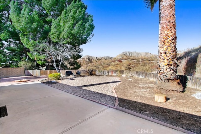 surrounding community featuring a mountain view and a patio area