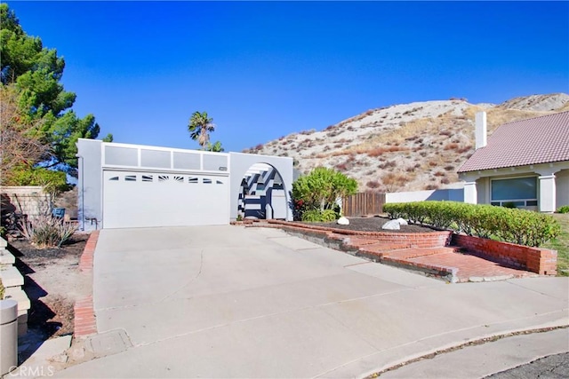 view of front of home with a mountain view and a garage