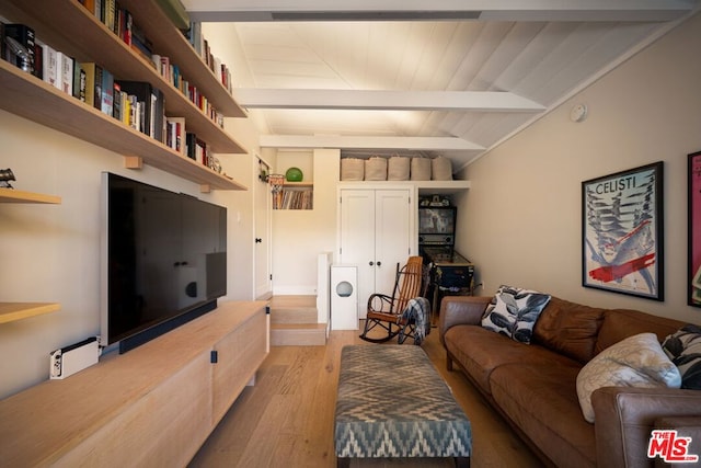 living room featuring vaulted ceiling with beams and light hardwood / wood-style floors