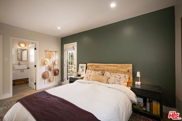 bedroom featuring sink and ensuite bath