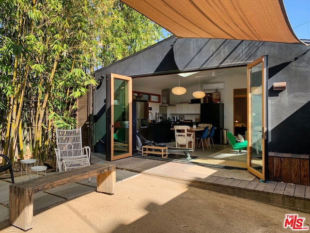 view of patio with a wall unit AC