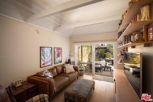 living room featuring hardwood / wood-style flooring and lofted ceiling with beams