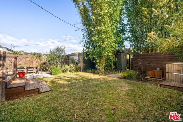 view of yard with a wooden deck