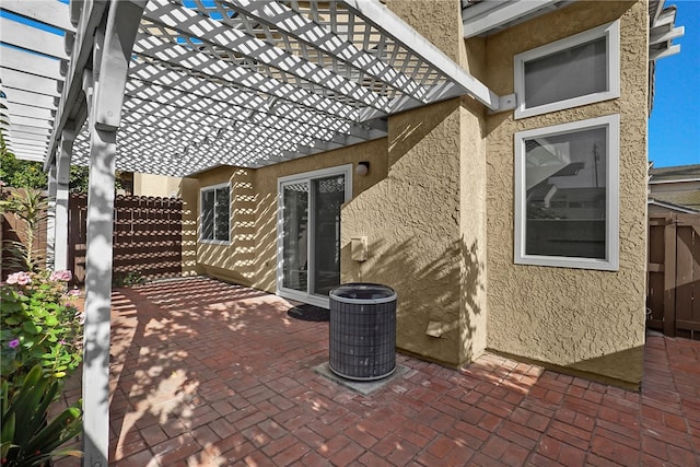 view of patio / terrace featuring central AC unit and a pergola