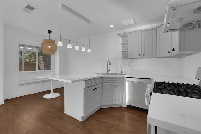 kitchen with sink, hanging light fixtures, stainless steel appliances, ventilation hood, and kitchen peninsula