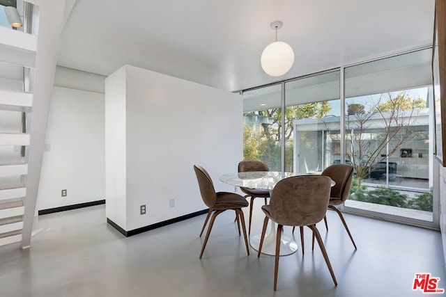 dining space featuring floor to ceiling windows